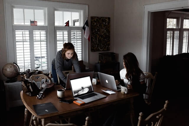 two women working with their laptops