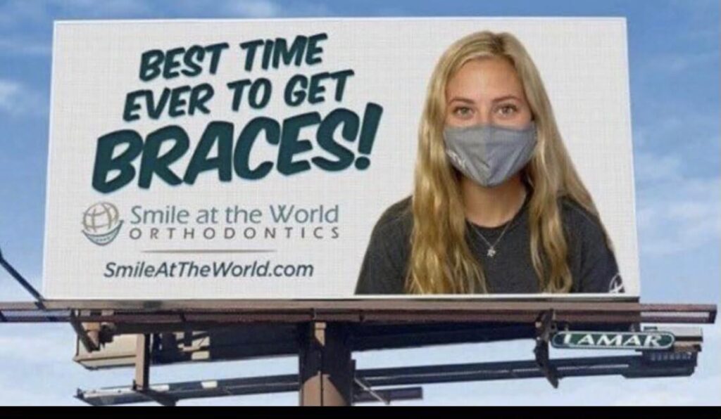 Guerilla marketing billboard: SmileAtTheWorld advertisement